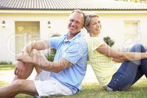 Couple Sitting Outside Dream Home