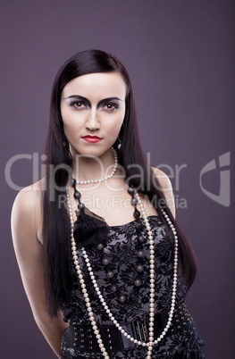 relaxed woman with long hair and pearl beads