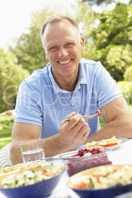 Man Enjoying Meal In Garden