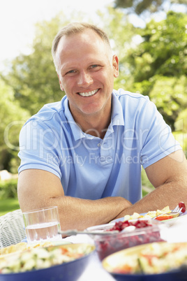 Man Enjoying Meal In Garden