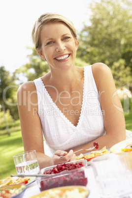 Woman Enjoying Meal In Garden