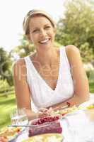 Woman Enjoying Meal In Garden