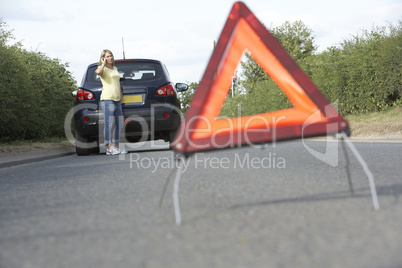 Female Driver Broken Down On Country Road With Hazard Warning Si