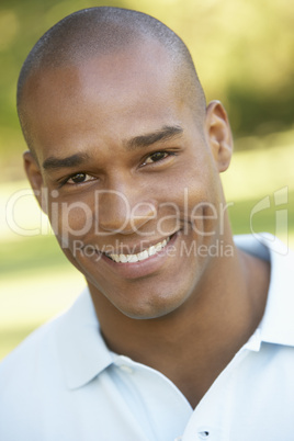 Portrait Of Young Man Sitting In Park