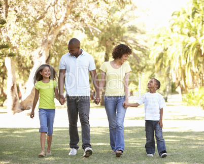 Portrait of Happy Family Walking In Park