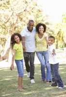 Portrait of Happy Family Walking In Park