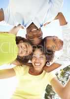 Portrait of Happy Family Looking Down Into Camera In Park