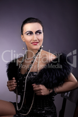 woman smile in fur boa and pearl beads