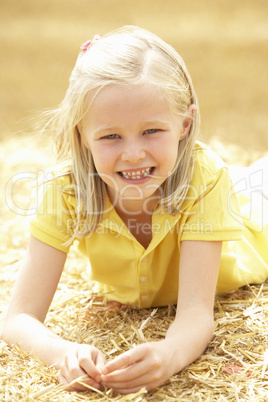 Portrait Of Girl Laying In Summer Harvested Field