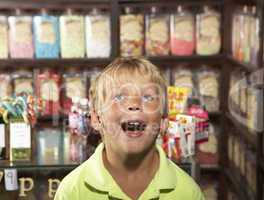 Excited Boy Standing In Sweet Shop
