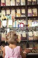Excited Girl Standing In Sweet Shop