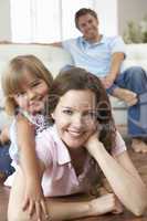 Portrait Of Happy Family Relaxing At Home