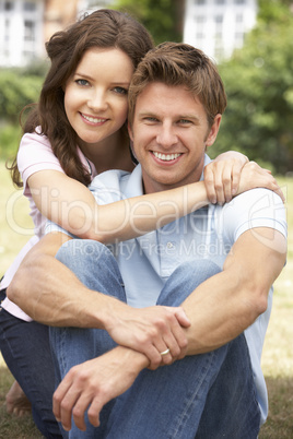 Affectionate Couple Relaxing At Home In Garden Together