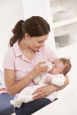 Mother Giving Bottle Baby Boy At Home