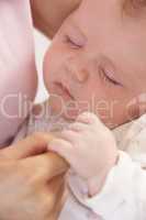 Close Up Of Sleeping Baby Boy Holding Mothers Hand