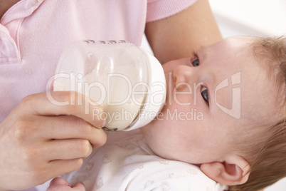 Mother Giving Bottle Baby Boy At Home