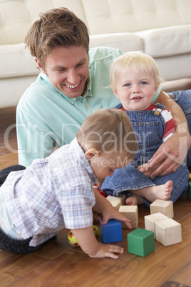 Father And Sons Playing With Coloured Blocks At Home