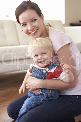 Mother Cuddling Son At Home