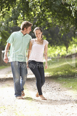 Affectionate Couple Walking In Countryside Together