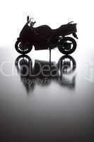 Silhouette of Street Motorcycle on Reflective Surface