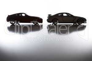 Silhouette of Sports Cars on Reflective Surface