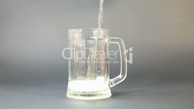 Beer is Pouring into mug