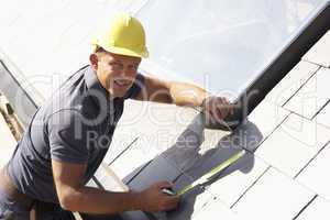 Roofer Working On Exterior Of New Home