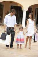 Young Family Enjoying Shopping Trip Together