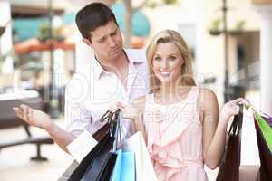 Man Frustrated With Woman On Shopping Trip Together