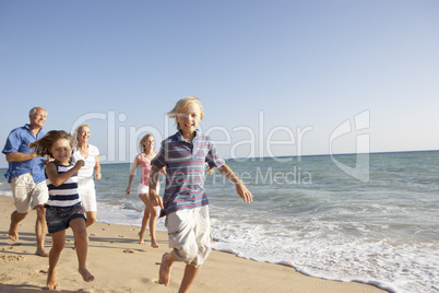 Portrait Of Three Generation Family On Beach Holiday