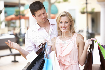 Man Frustrated With Woman On Shopping Trip Together