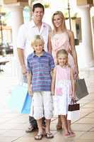 Young Family Enjoying Shopping Trip Together