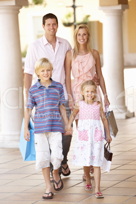 Young Family Enjoying Shopping Trip Together Young Family Enjoying Shopping Trip Together