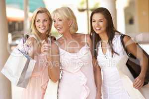 Senior Mother And Daughters Enjoying Shopping Trip Together