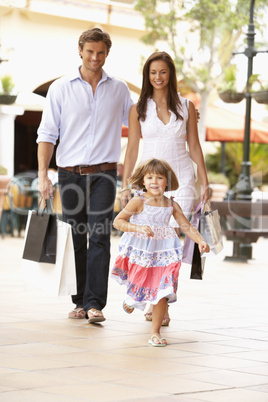 Young Family Enjoying Shopping Trip Together