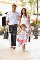 Young Family Enjoying Shopping Trip Together