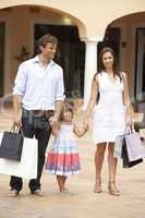 Young Family Enjoying Shopping Trip Together