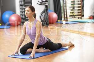 Woman Doing Stretching Exercises In Gym