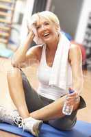 Senior Woman Resting After Exercises In Gym