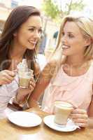 Two Young Women Enjoying Cup Of Coffee In Caf?