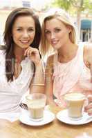 Two Young Women Enjoying Cup Of Coffee In Caf?