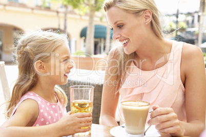 Mother And Daughter Enjoying Cup Of Coffee And Juice In Caf? Tog