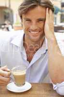 Young Man Enjoying Cup Of Coffee In Caf?
