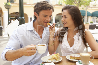 Young Couple Enjoying Coffee And Cake In Caf?