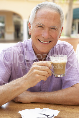 Senior Man Enjoying Coffee And Cake In Caf?