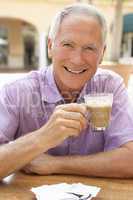 Senior Man Enjoying Coffee And Cake In Caf?