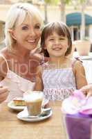 Grandmother With Granddaughter Enjoying Coffee And Cake In Caf?