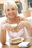 Senior Woman Enjoying Coffee And Cake In Caf?