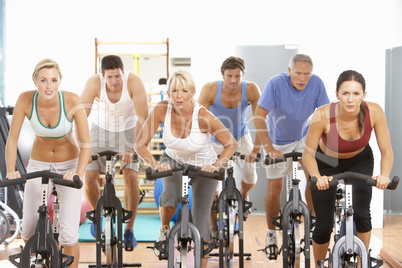 Group Of People In Spinning Class In Gym