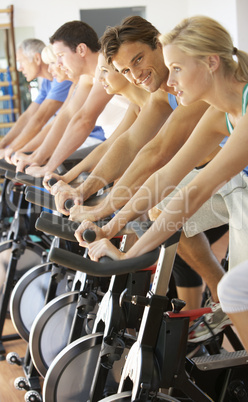 Man Cycling In Spinning Class In Gym
